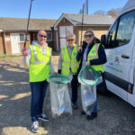 adults in high viz jackets with litter pickers read to go on a litter pick